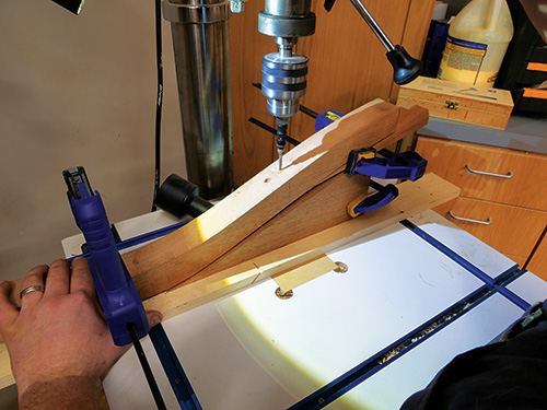 Drilling jig for cutting holes in love seat legs