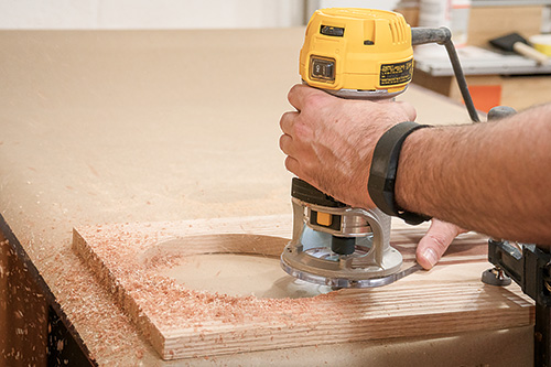 Routing strainer hole in over the sink cutting board