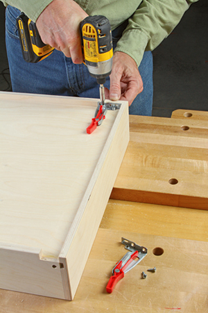 Adding release levers to storage chest drawer