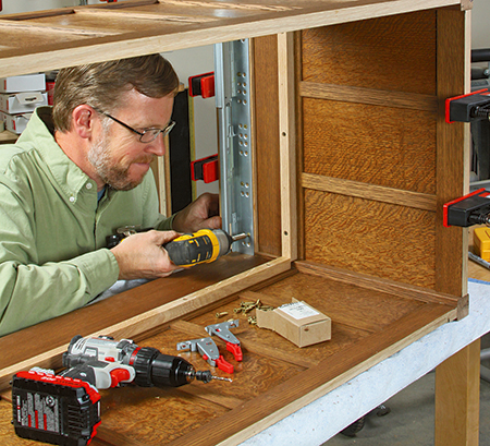 Adding drawer hardware to storage chest carcass