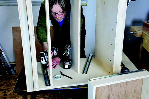 Position the glide's lower edge flush with the top of the door stop rail and use a square to assure that the glide is square to the cabinet's front edge.