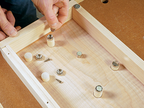 Magnets installed in tool cabinet door tool holder