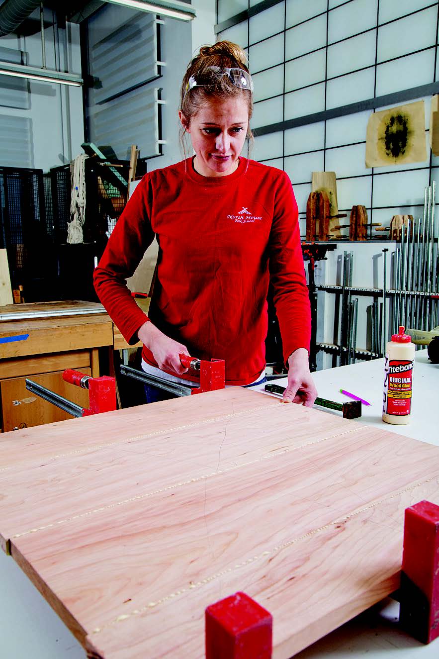 Gluing together parts of end table tabletop