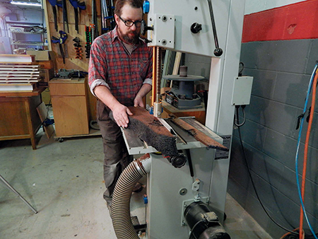 Cutting strips from redwood slab at band saw