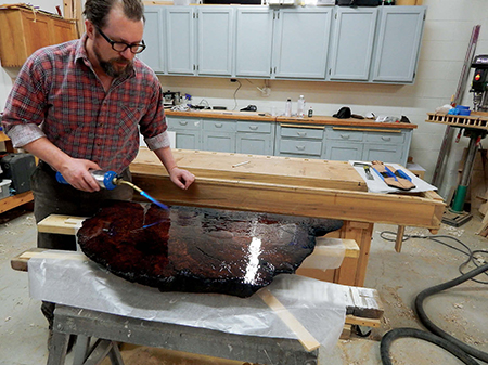 Removing bubbles from epoxy topcoat with torch