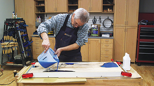 Pouring epoxy mixture into spalted maple piece