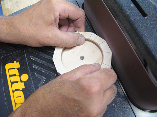 Sanding down the edges of the clock face