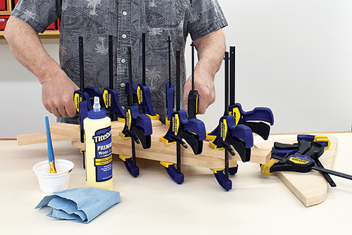 Gluing and clamping task light baseplate parts together