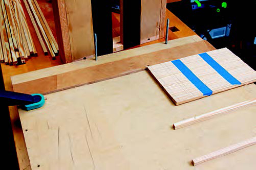 The lap-joint jig (see Drawing, page 58) allows you to gang-cut the lattice dadoes. Tape the strips together and then mark the joint positions.