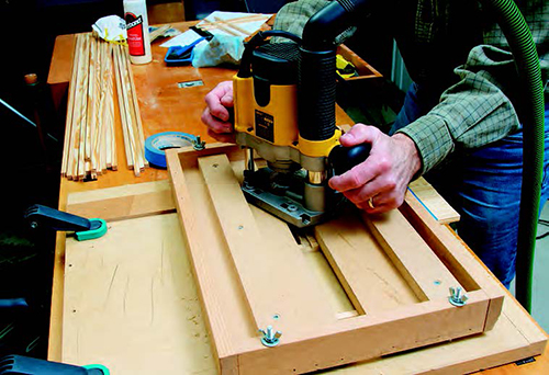 Use a plunge router and 3/8” straight bit to cut the dadoes in the lattice strips. Set the fences in the router carriage to work with your router's base. In this case, twisting the router between the fences produced the least amount of friction and the best stability and accuracy.
