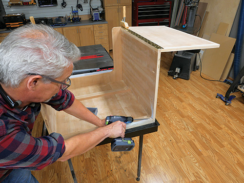 Installing lift supports inside sewing cabinet