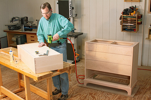 Attaching drawer bottom with a pin nailer.