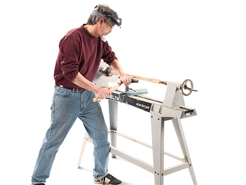 Spindle turning Shaker end table legs at a lathe