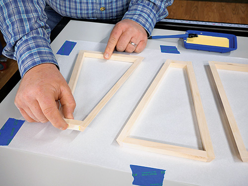 Laying out lamp frame on rice paper to measure it