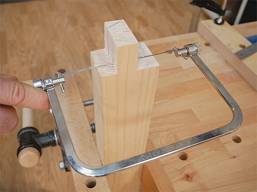 Cleaning table leg joint kerf with fret saw