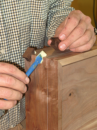 Using silicone brush to spread glue to attach wenge keys