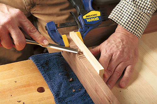 Using chisel to clean up hinge installation locations