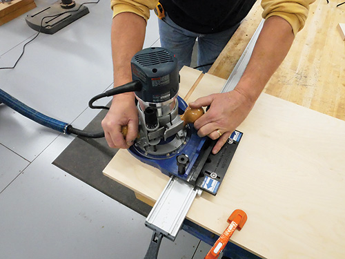 Making first pass cut with router plate and rail
