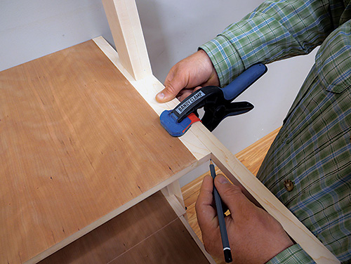 Marking out location for standing desk shelf stops