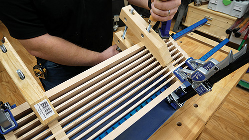Clamping shelf slats in place after glue-up