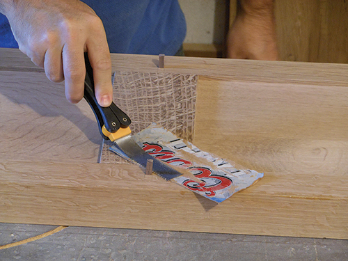 Cutting down dowel peg with cardboard buffer