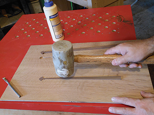 Hammering spade-shaped inlays into place