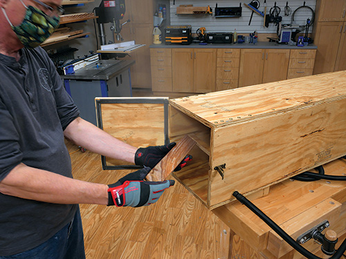 Placing wood in steam bending chamber while wearing gloves