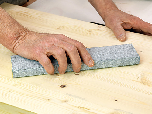 Finish sanding a panel with a large sanding block