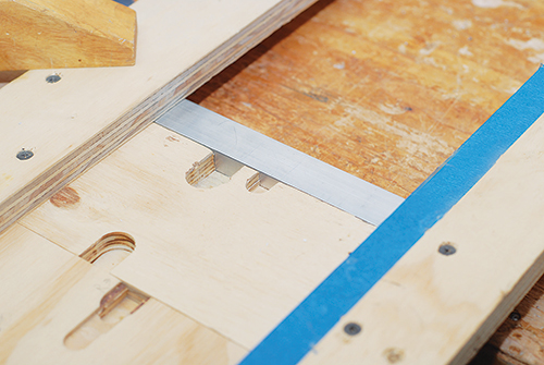 Shop-made dado jig for routing metal coffee table stretcher