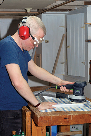 Buffing metal coffee table legs with sander