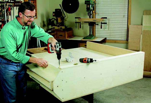 Attaching bin face to panel storage cabinet