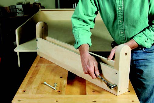 Final assembly of panel storage system's swing-out arm