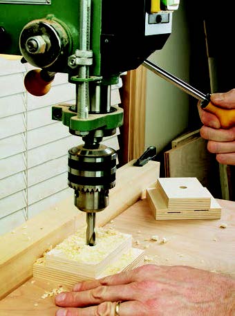 Using drill press to cut bolt hole for panel storage end