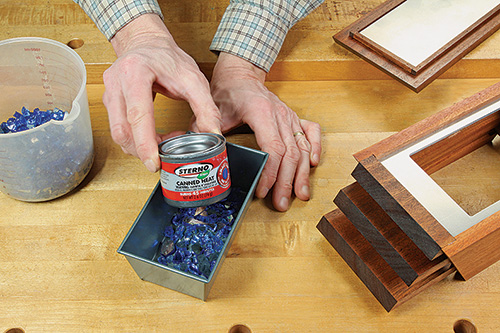 Installing fuel can in tabletop fire pit pan