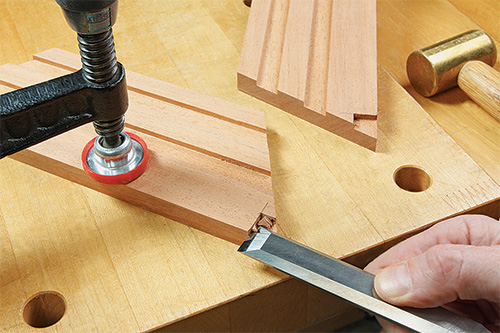 Cleaning out end grooves on tabletop fire pit with chisel