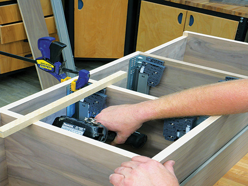 Installing drawer slides in wall cabinet carcass