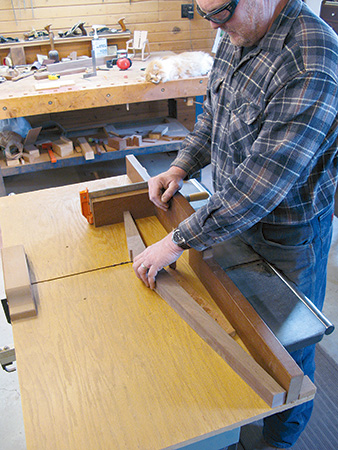 Using a temporary fence to align a table saw leg