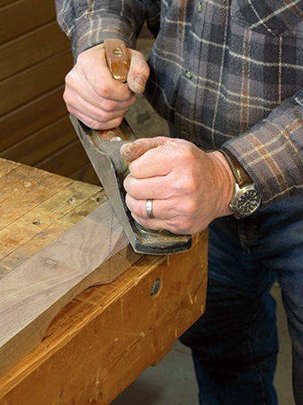 Hand planing a crest rail.