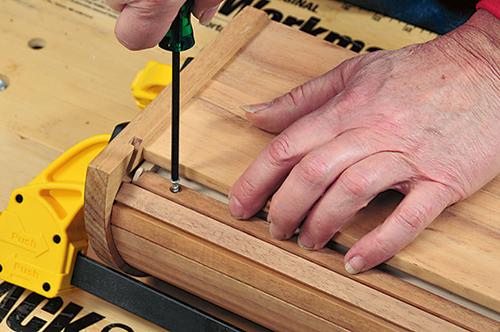 Screwing tambour top into box assembly