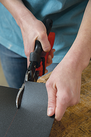 Trimming chalkboard panel to size with tin cutter