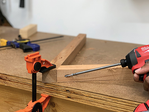 Clamping frame parts to table for screw installation