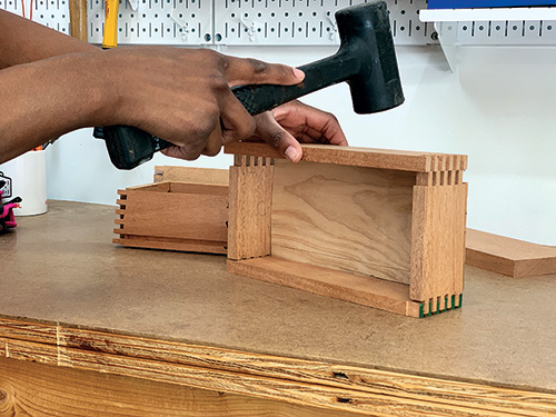 Hammering planter box side panel joints in place