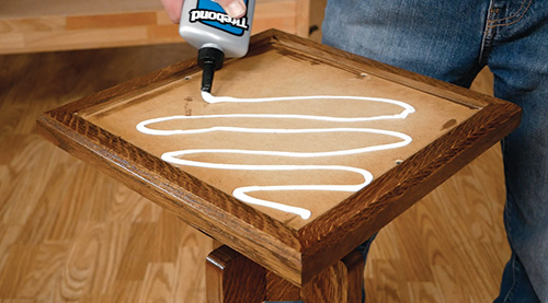 Adding Titebond Quick and Thick glue to top of plant stand to add tile tabletop