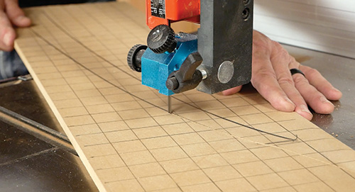 Cutting out plant stand leg template with gridded drawing