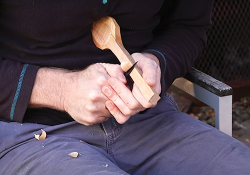Finishing the shaping of the carved spoon's handle