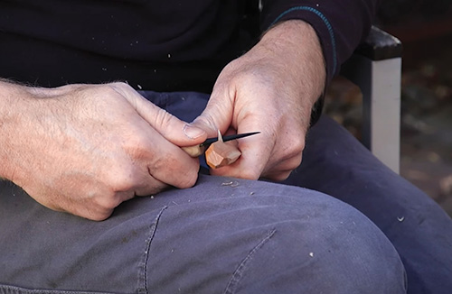 Making final cuts to carved spoon handle end