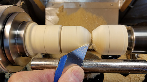 Separating candy and wrapper sections with parting tool