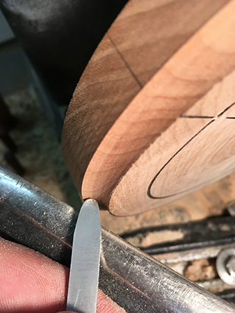 Turning cove indentation on edge of blank