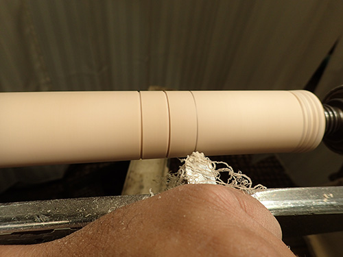 Cutting decorative lines in lamp blank with chisel