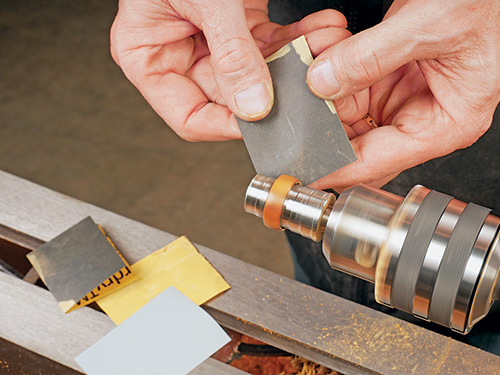 Sanding down ring shape as it turns on lathe